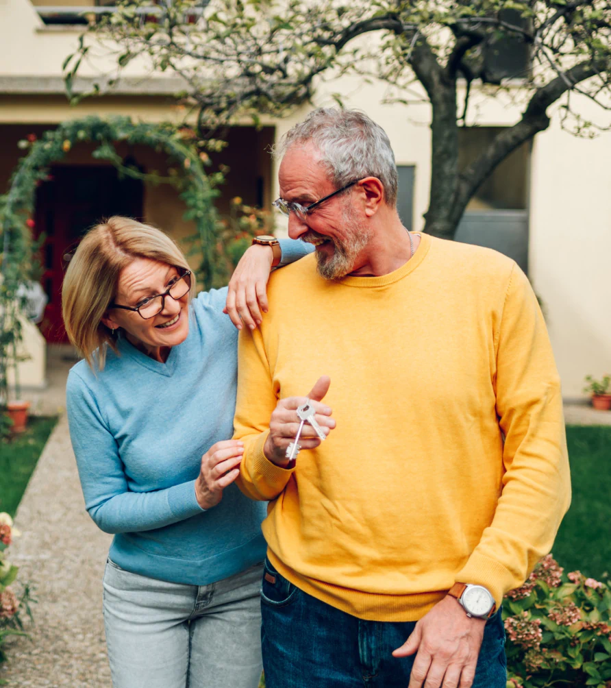 couple-outside-home-holding-keys